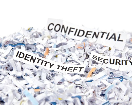 shredded paper with the words confidential, security and identity theft
